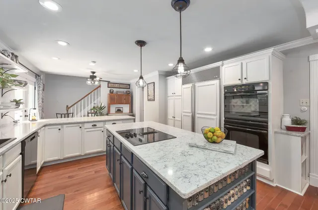 a kitchen with a stove a faucet a dinning table and chairs
