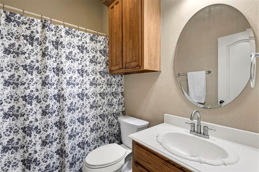 105 Country Ridge Court Red Oak, TX 75154 - Photo 32 of 40 a bathroom with a sink toilet and mirror