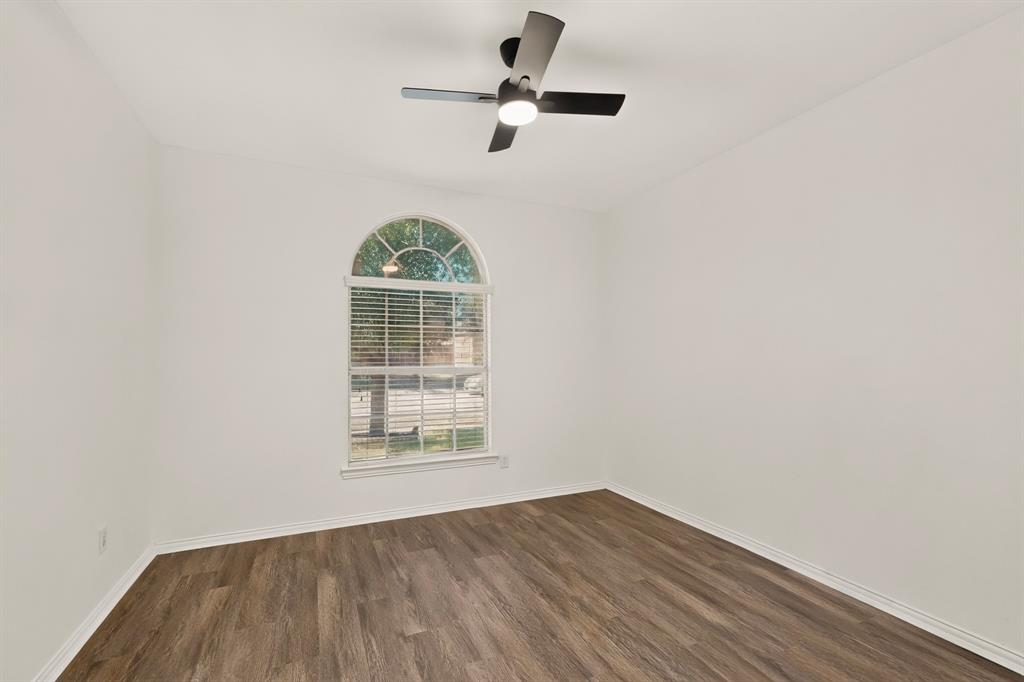 14908 Riverside Drive Little Elm, TX 75068 - Photo 27 of 40 Arched window with blinds, wood-finish flooring, and a ceiling fan with integrated lighting