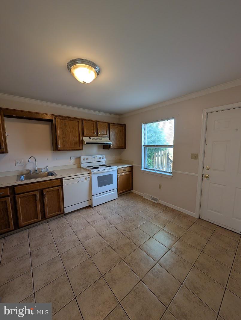 859 Old Silver Springs Road Mechanicsburg, PA 17055 - Photo 21 of 28 a large kitchen with stainless steel appliances granite countertop a stove a sink and a microwave