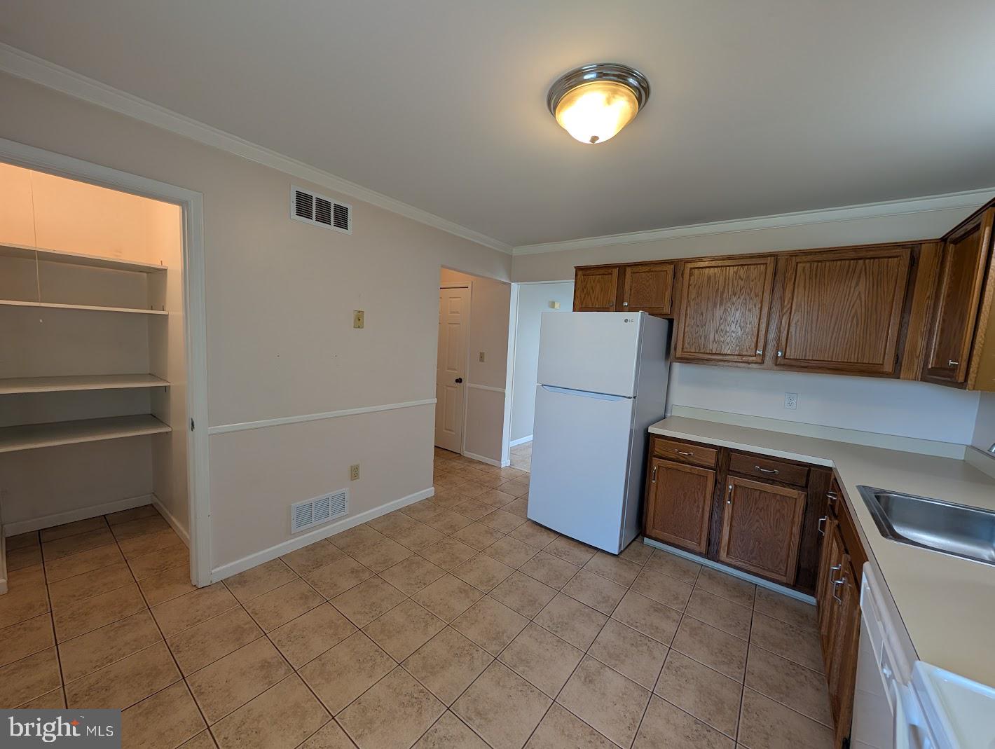 859 Old Silver Springs Road Mechanicsburg, PA 17055 - Photo 25 of 28 a kitchen with a refrigerator and cabinets
