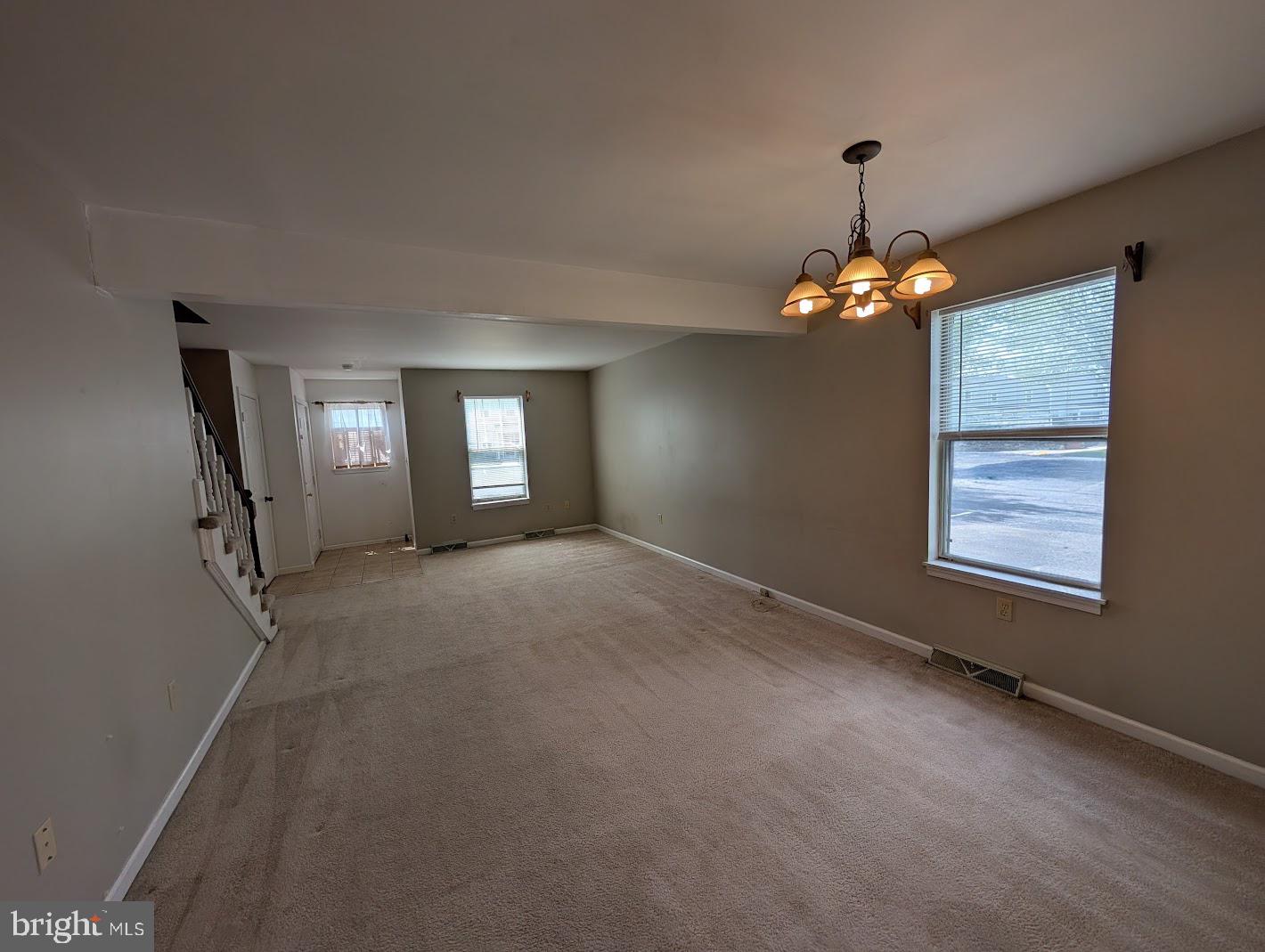 859 Old Silver Springs Road Mechanicsburg, PA 17055 - Photo 4 of 28 an empty room with windows and chandelier