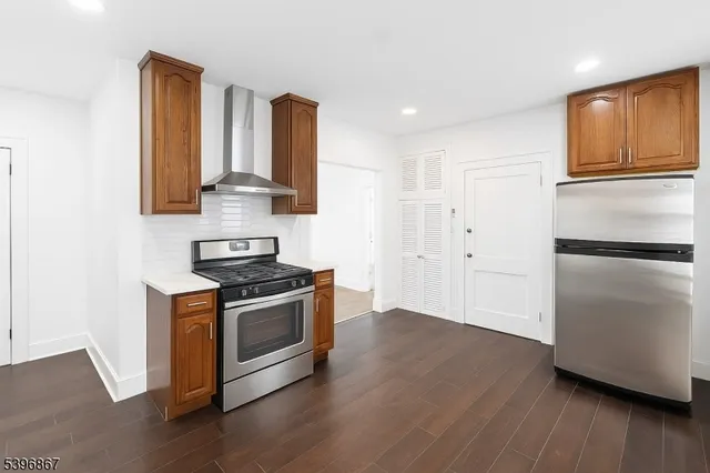 a kitchen with stainless steel appliances granite countertop a stove and a refrigerator