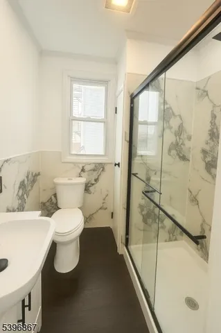 a white toilet sitting next to a bathroom sink