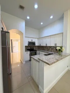 a kitchen with a stove a sink and a refrigerator