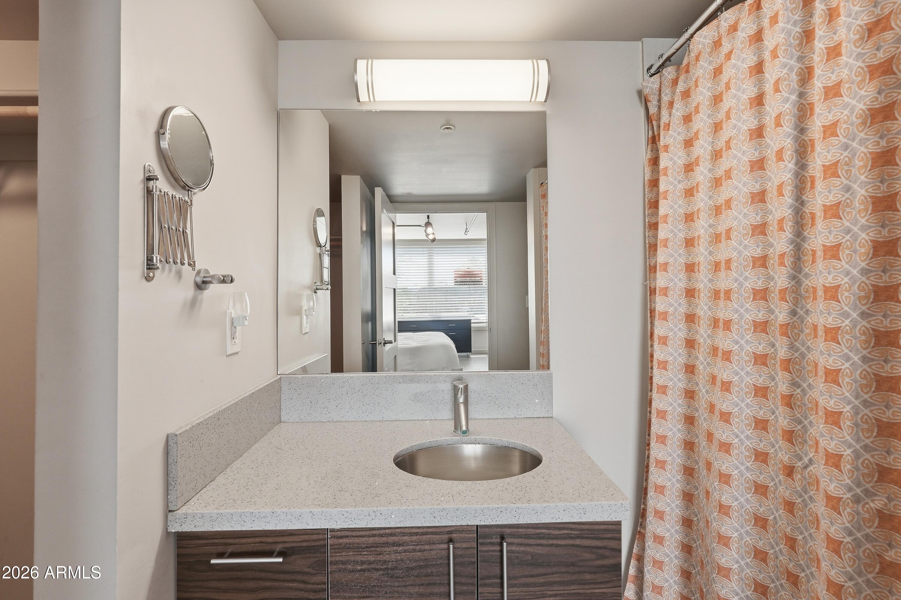 535 West Thomas Road, Unit 210 Phoenix, AZ 85013 - Photo 23 of 40 a bathroom with a sink and a mirror