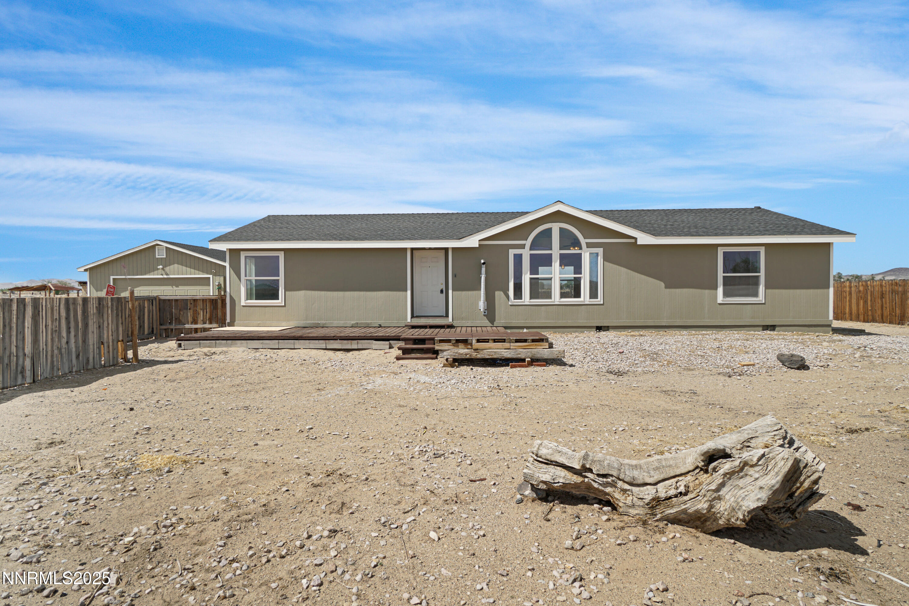 a view of a house with wooden fence