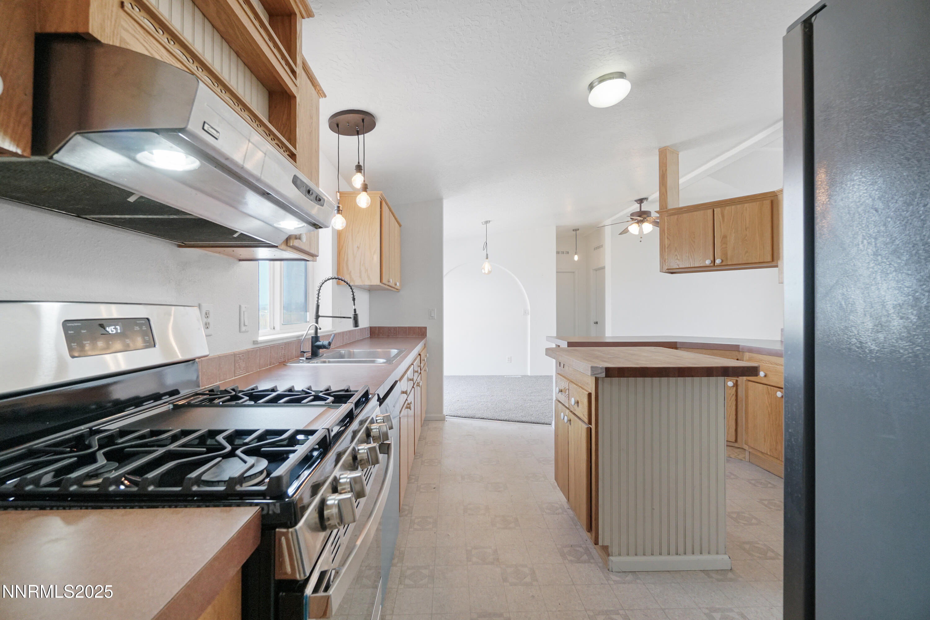 11575 Fulkerson Road Fallon, NV 89406 - Photo 11 of 25 a kitchen with stainless steel appliances granite countertop a stove and a refrigerator