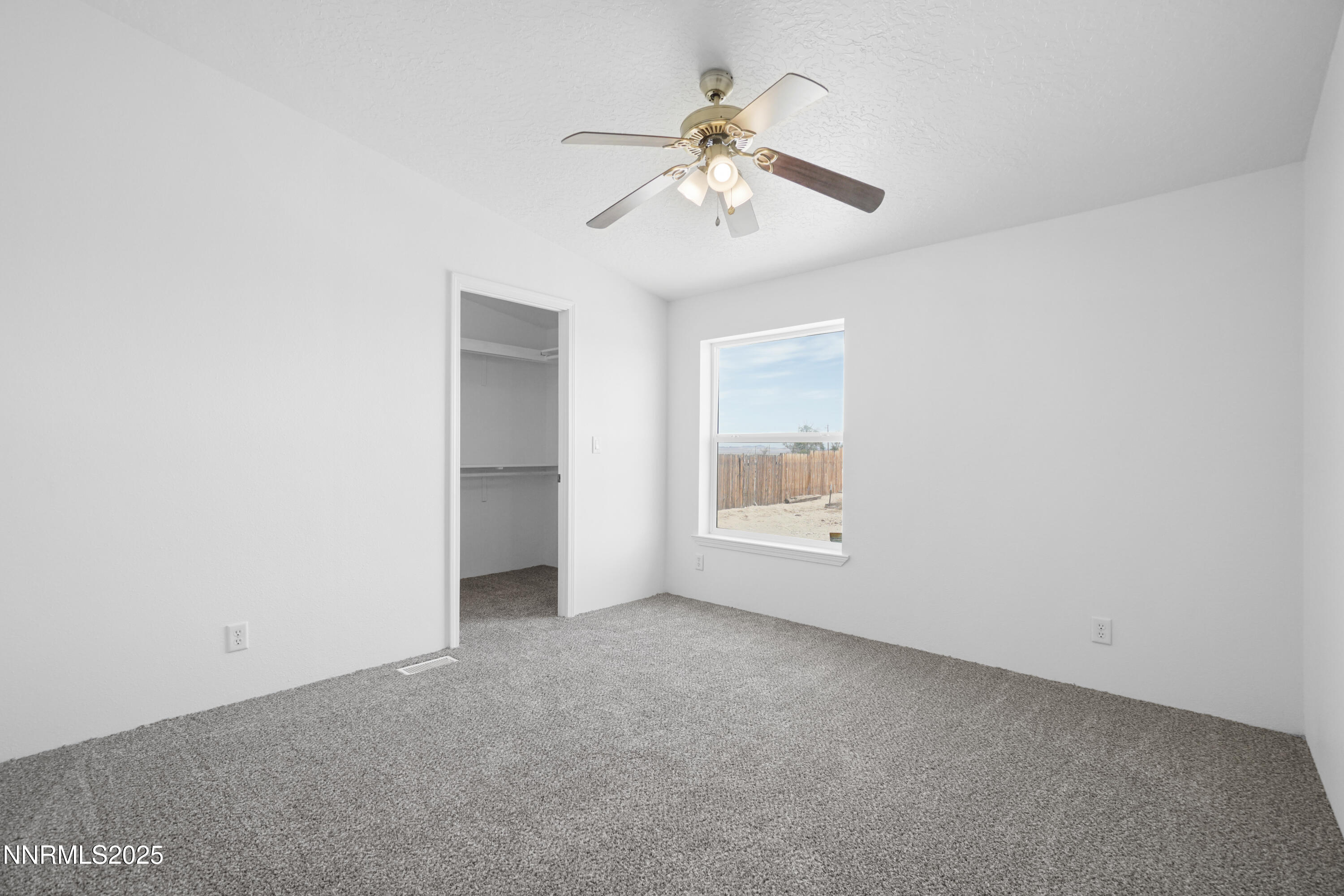 11575 Fulkerson Road Fallon, NV 89406 - Photo 15 of 25 an empty room with chandelier fan and windows