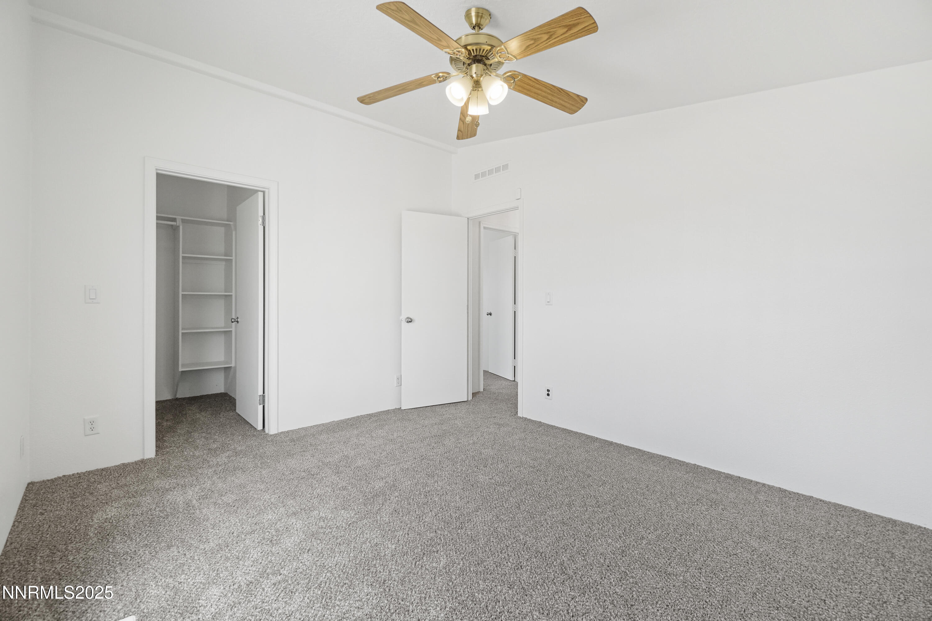 11575 Fulkerson Road Fallon, NV 89406 - Photo 18 of 25 an empty room with a ceiling fan and a fan