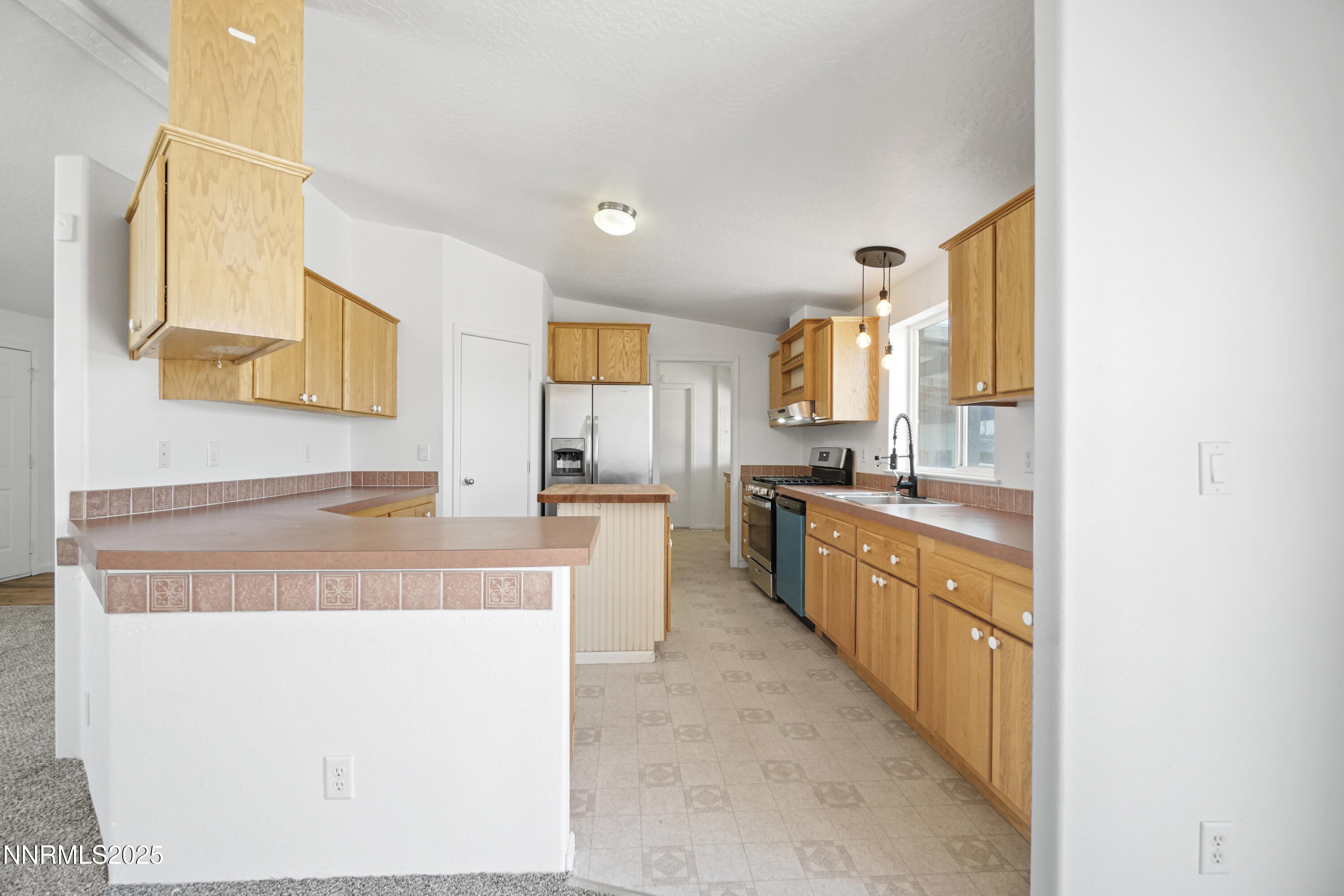 11575 Fulkerson Road Fallon, NV 89406 - Photo 8 of 25 a large kitchen with kitchen island granite countertop wooden cabinets a granite counter tops and a stove