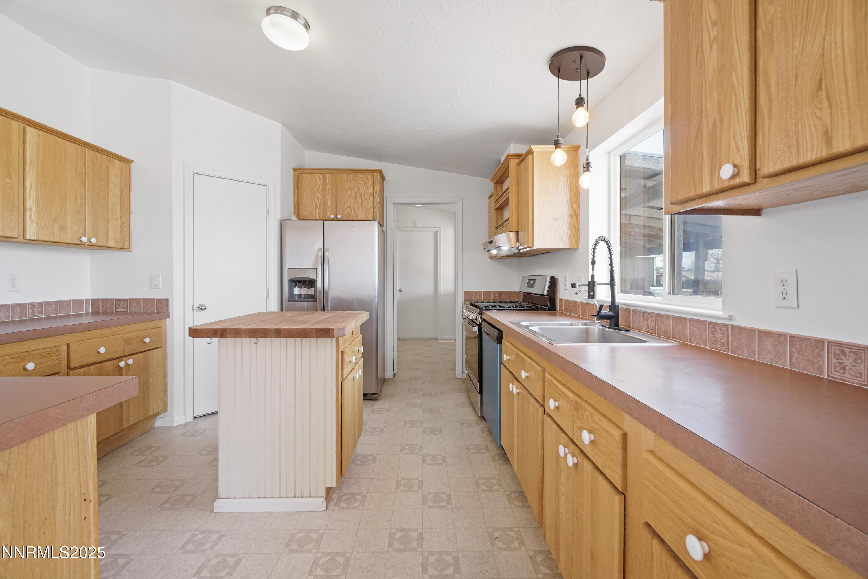 11575 Fulkerson Road Fallon, NV 89406 - Photo 10 of 25 a kitchen with sink cabinets and window