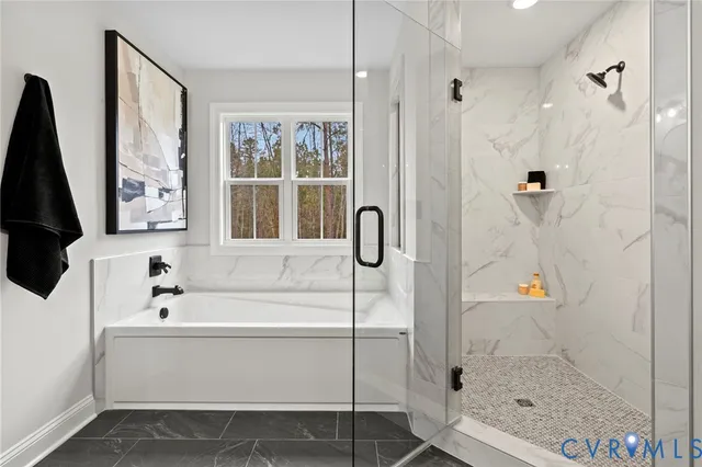 a bathroom with a tub a sink and a large mirror