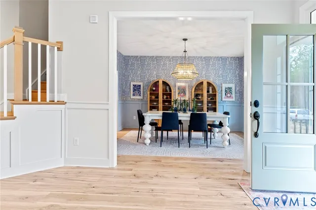 a view of a a dining room with furniture window and wooden floor