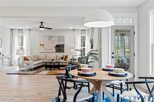 a living room with furniture a table and a chandelier
