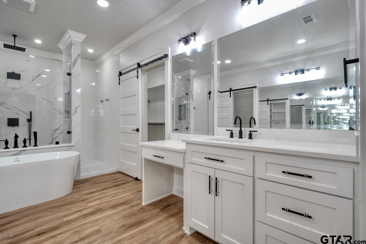 19383 Ridge Point Circle Lindale, TX 75771 - Photo 27 of 48 a spacious bathroom with a sink a large mirror and shower