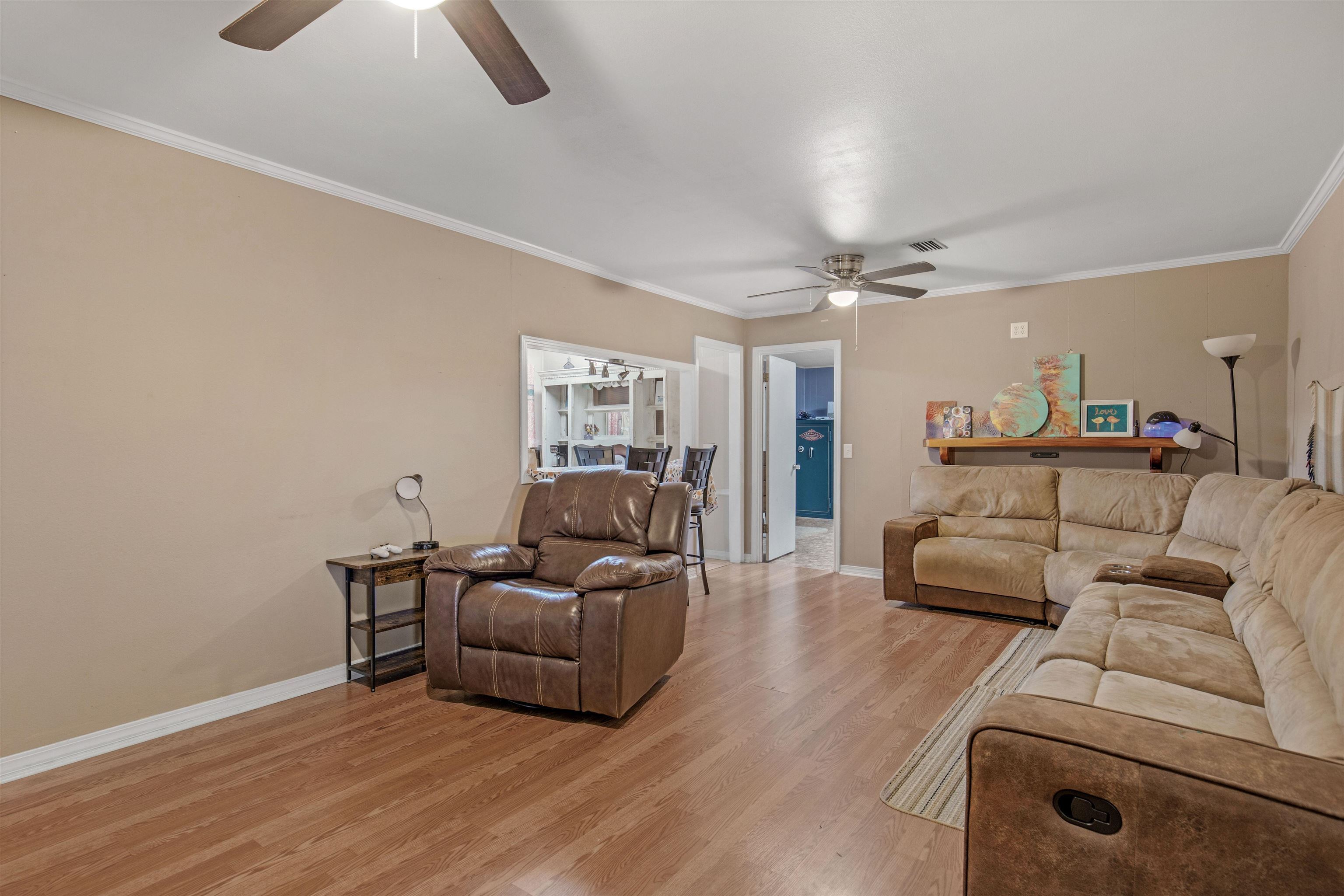 1147 Mack Pond Road Atmore, AL 36502 - Photo 9 of 40 Living room with ceiling fan, light hardwood / wood-style floors, and ornamental molding