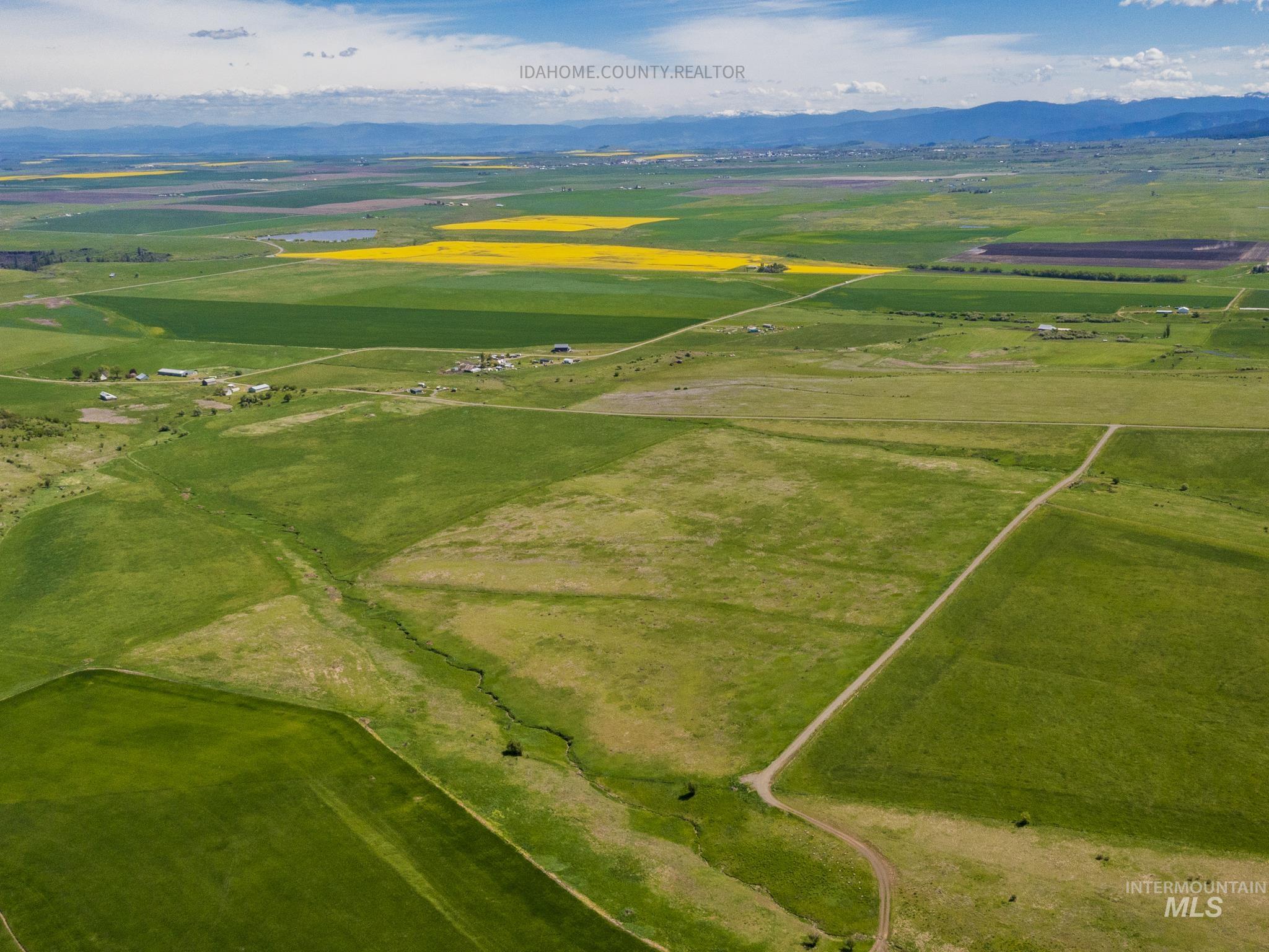 3 Freebird Way Grangeville, ID 83530 - Photo 18 of 43 Aerial view of sparsely populated area featuring a mountainous background and extensive farmland