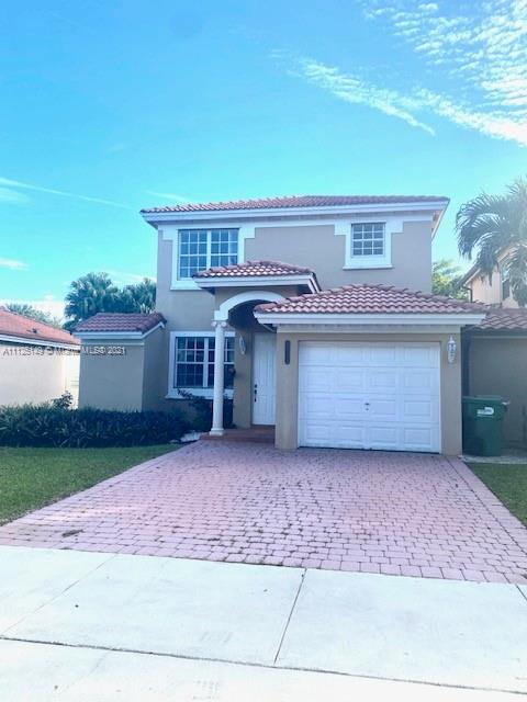 a view of a house with a yard and garage