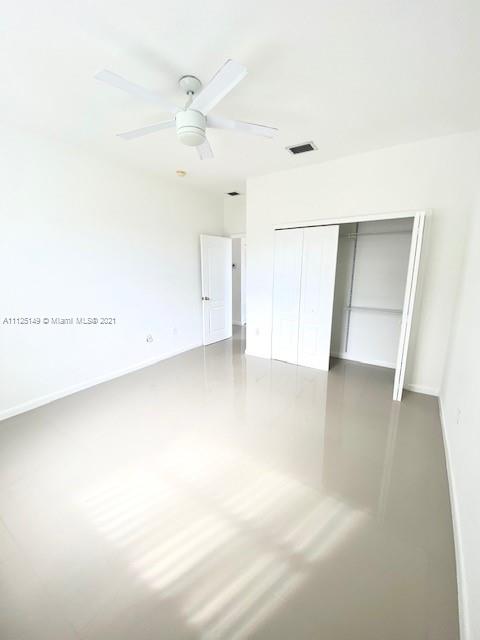 15368 Southwest 25th Terrace Miami, FL 33185 - Photo 20 of 30 an empty room with a ceiling fan and wooden floor