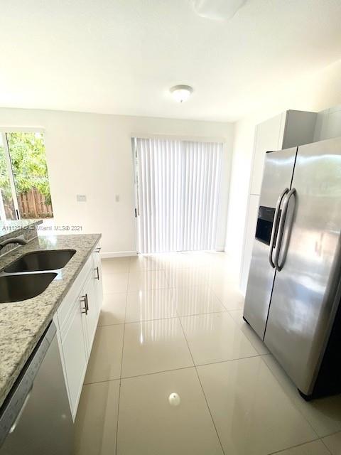 15368 Southwest 25th Terrace Miami, FL 33185 - Photo 3 of 30 a kitchen with granite countertop a sink and a stove top oven