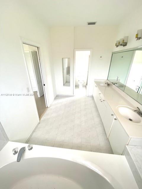 15368 Southwest 25th Terrace Miami, FL 33185 - Photo 21 of 30 a bathroom with a tub sink and a mirror