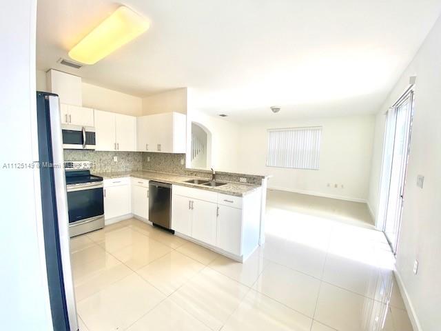 15368 Southwest 25th Terrace Miami, FL 33185 - Photo 6 of 30 a kitchen with a sink cabinets stainless steel appliances and a window