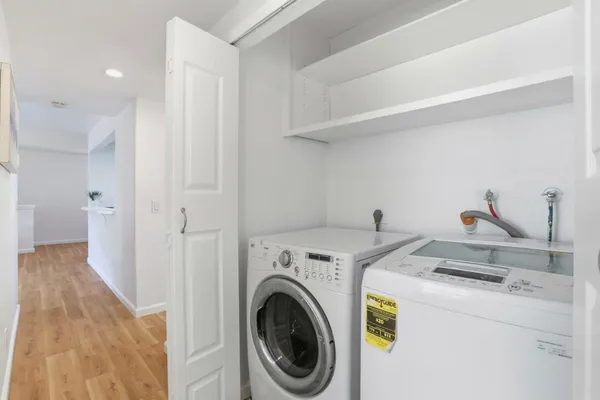 a view of storage and utility room with washer and dryer