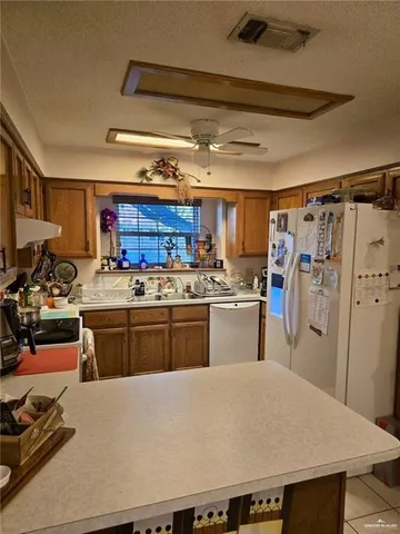 a kitchen with stainless steel appliances granite countertop a refrigerator and a stove