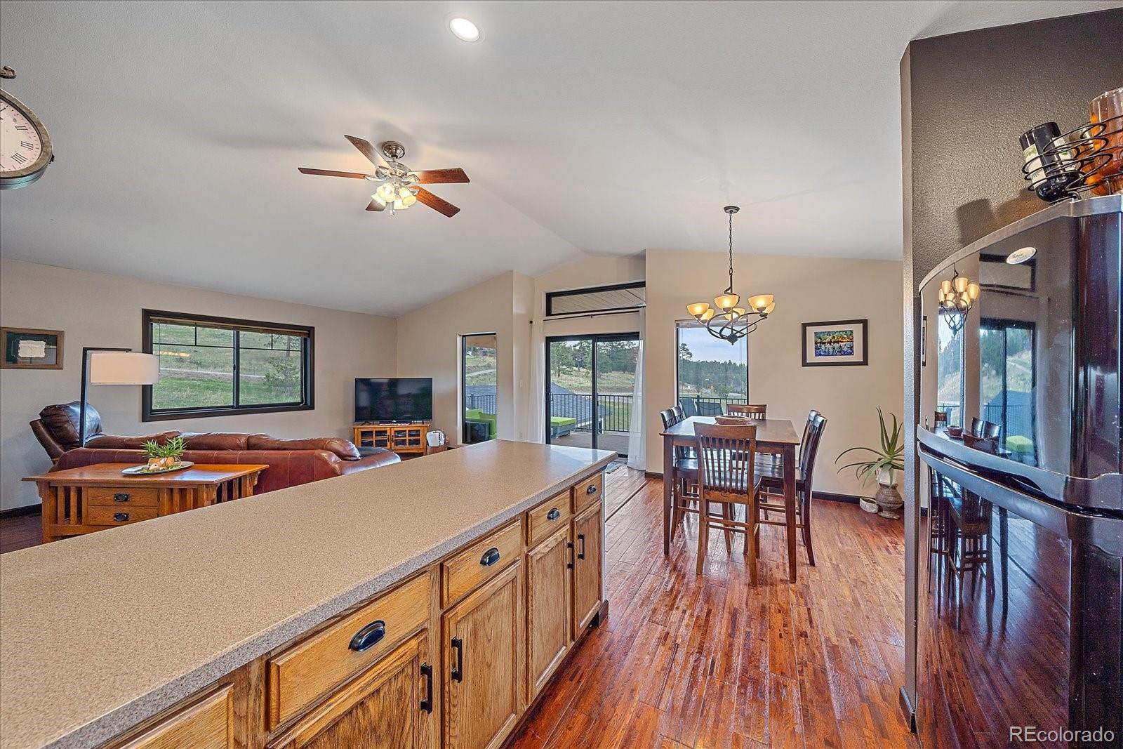 26035 Amy Circle Conifer, CO 80433 - Photo 14 of 38 a view of a dining room with furniture window and wooden floor