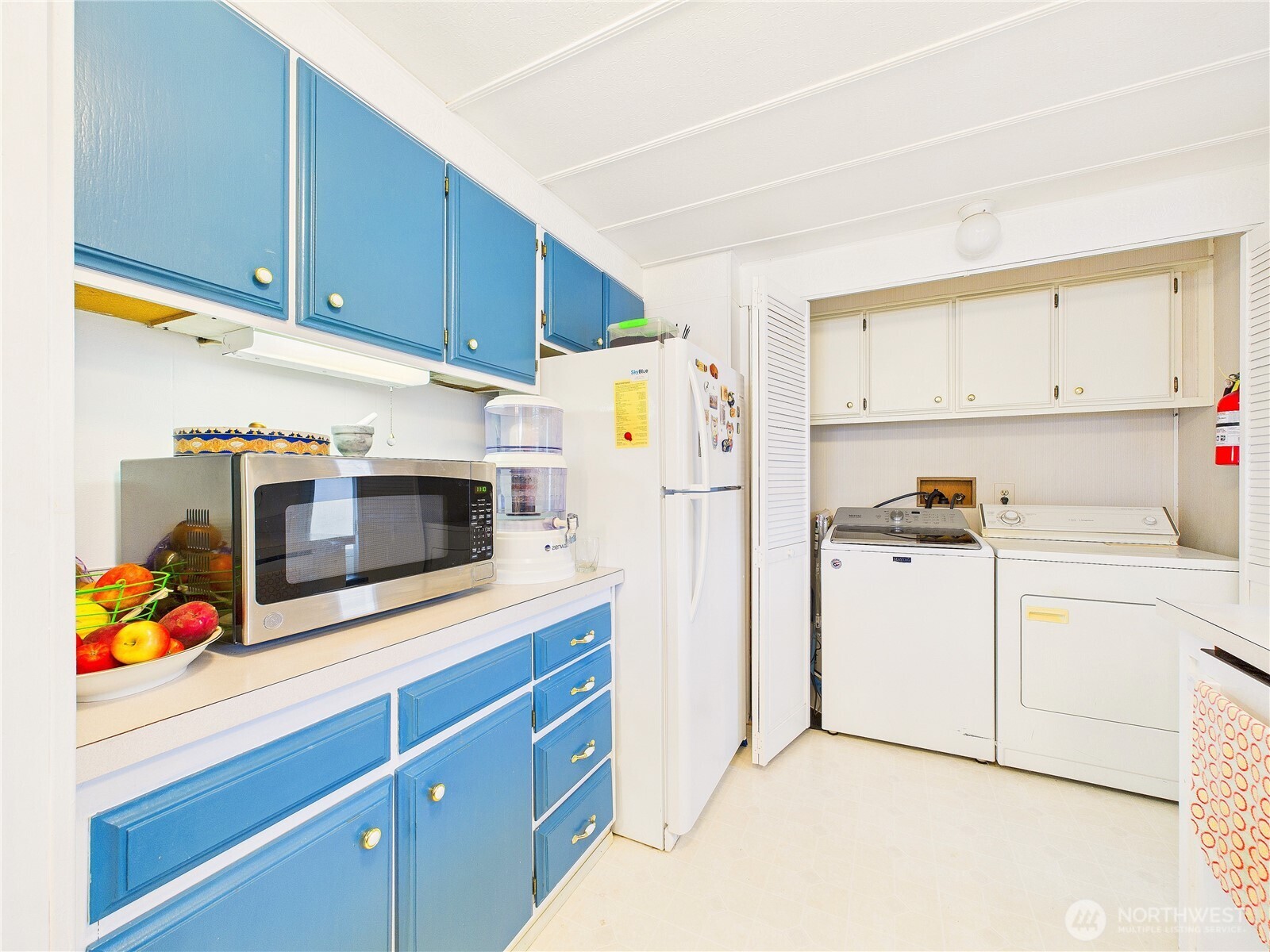 4805 Cushman Road Northeast, Unit 56 Olympia, WA 98506 - Photo 16 of 30 a kitchen with stainless steel appliances white cabinets and wooden floor
