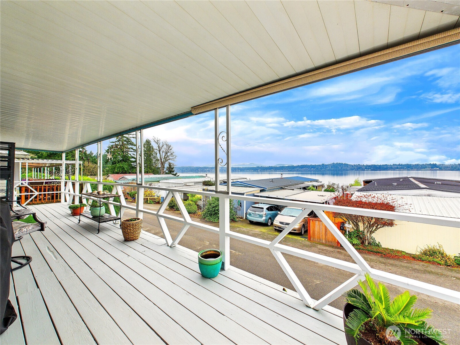 4805 Cushman Road Northeast, Unit 56 Olympia, WA 98506 - Photo 2 of 30 a view of a balcony with dining table and chairs with wooden floor