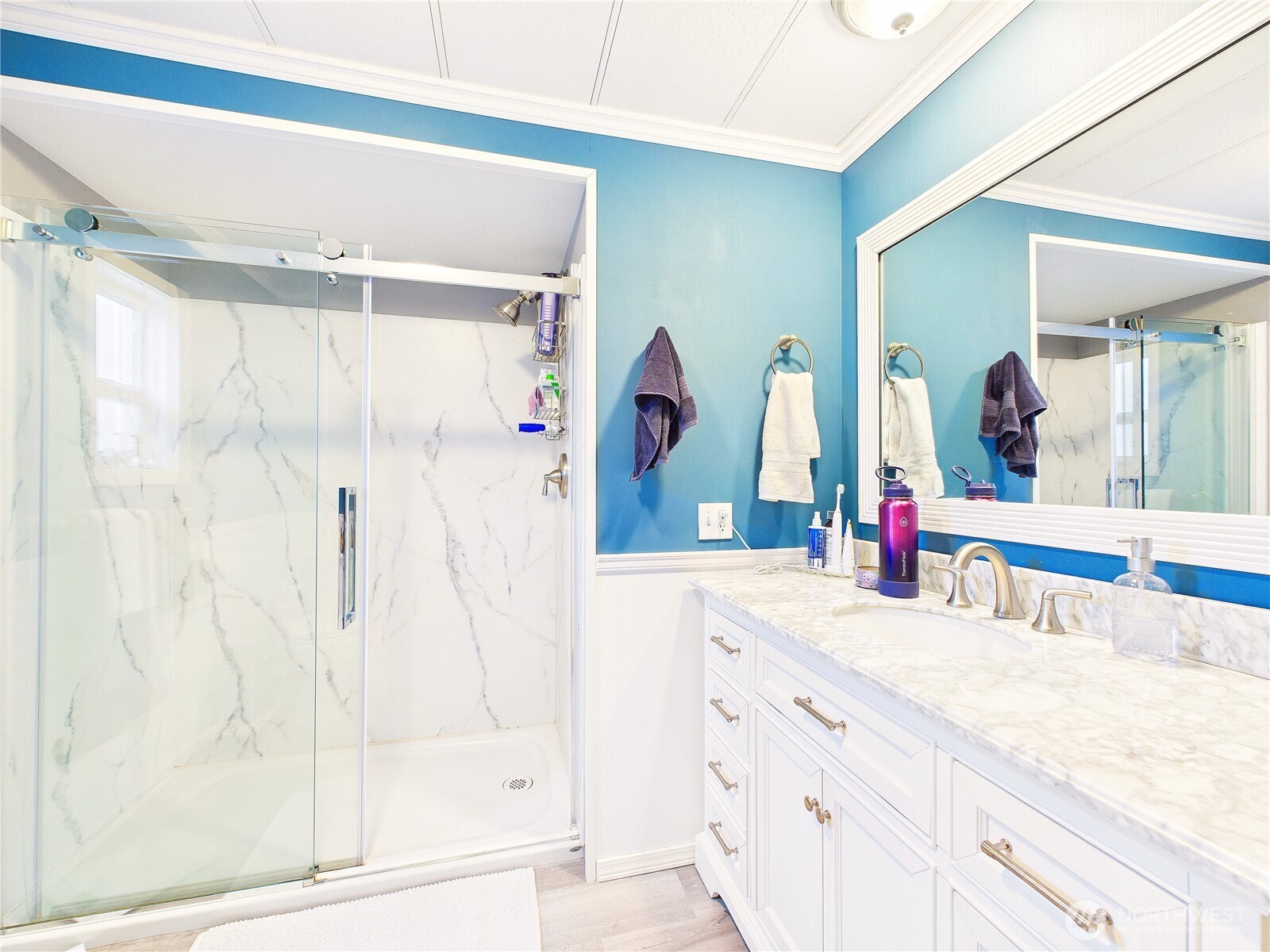 4805 Cushman Road Northeast, Unit 56 Olympia, WA 98506 - Photo 25 of 30 a bathroom with a granite countertop sink mirror and a shower