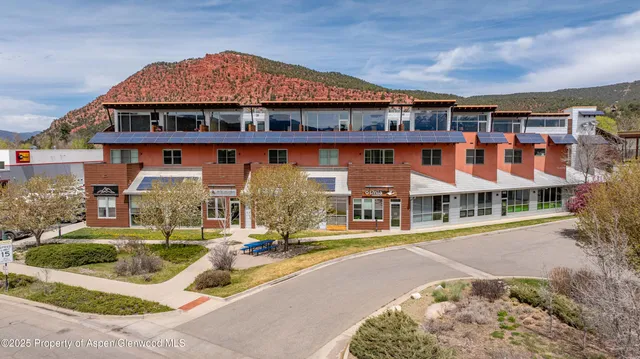 front view of a building with a garden