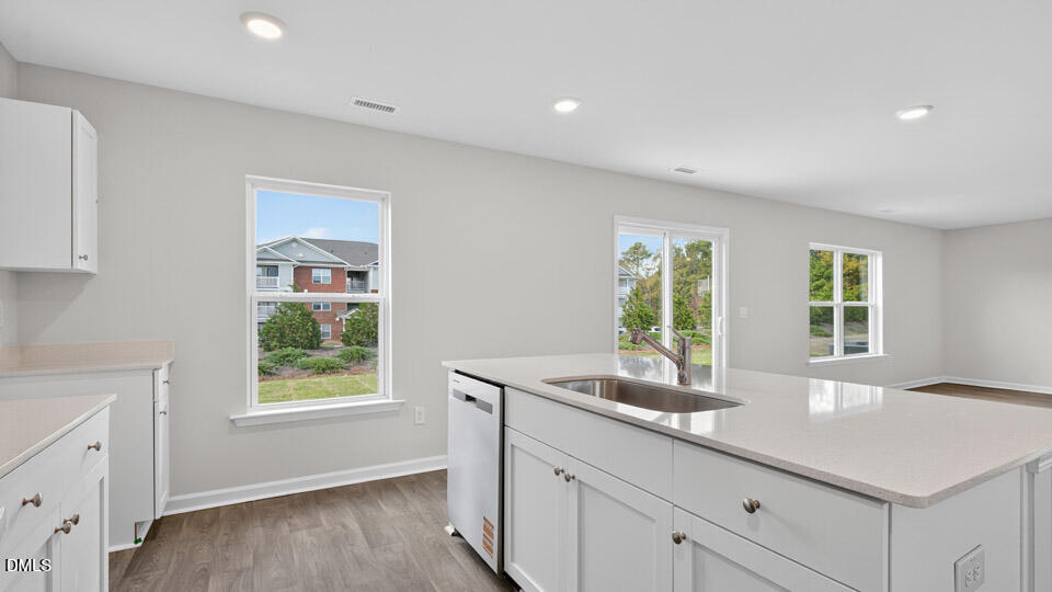 3604 Turney Drive Raleigh, NC 27610 - Photo 13 of 39 a kitchen with granite countertop a sink and a window