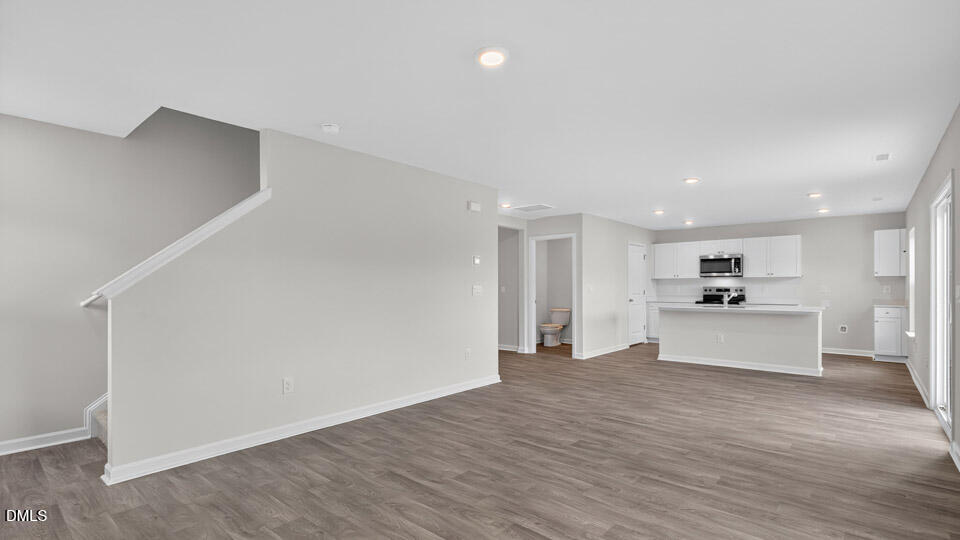 3604 Turney Drive Raleigh, NC 27610 - Photo 7 of 39 a view of a kitchen with a sink and a refrigerator