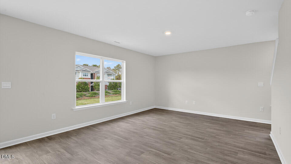 3604 Turney Drive Raleigh, NC 27610 - Photo 8 of 39 an empty room with wooden floor and windows