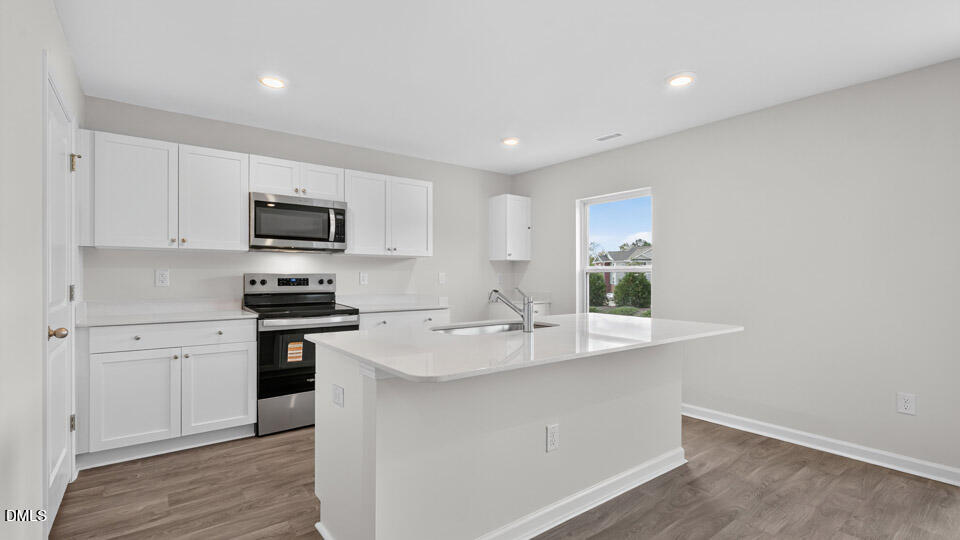 3604 Turney Drive Raleigh, NC 27610 - Photo 9 of 39 a kitchen with appliances a sink and cabinets