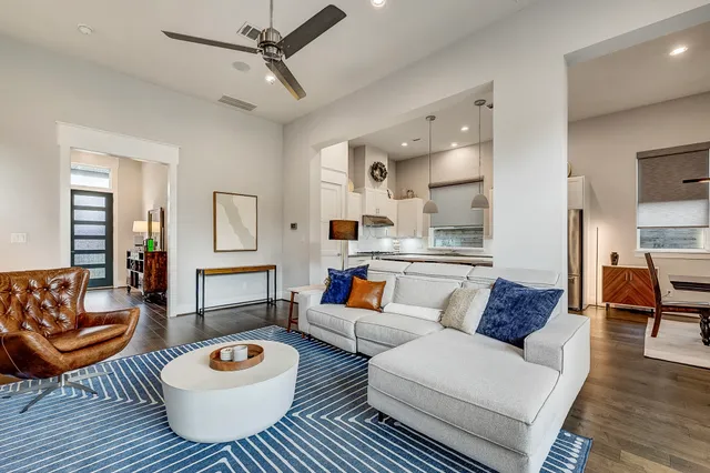 a living room with furniture a rug and a chandelier