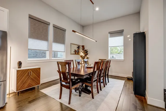 a view of a dining room with furniture and wooden floor