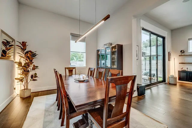 a dining room with furniture window and wooden floor