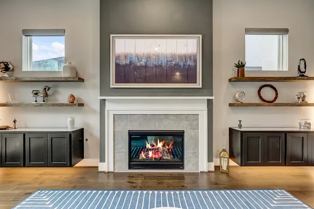 a living room with furniture a fireplace and a flat screen tv