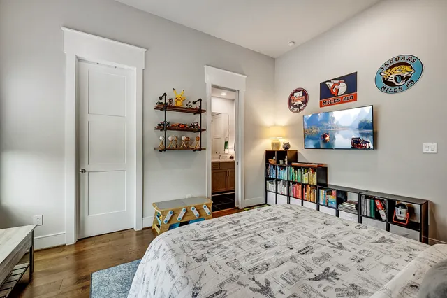 a bedroom with a bed and wooden floor