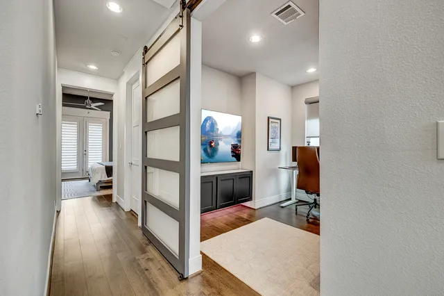 a view of a livingroom with furniture and hardwood floor