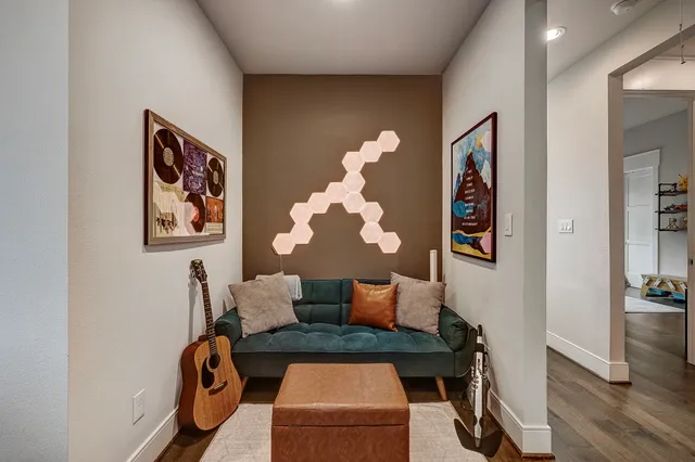 a living room with furniture and wooden floor