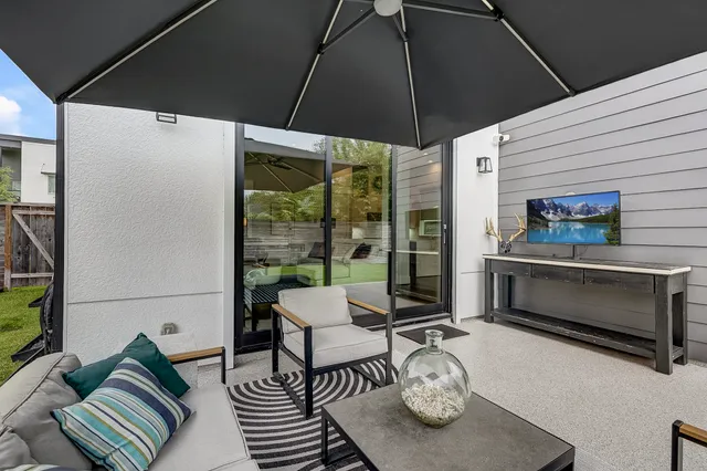 a view of a backyard with plants and a bench