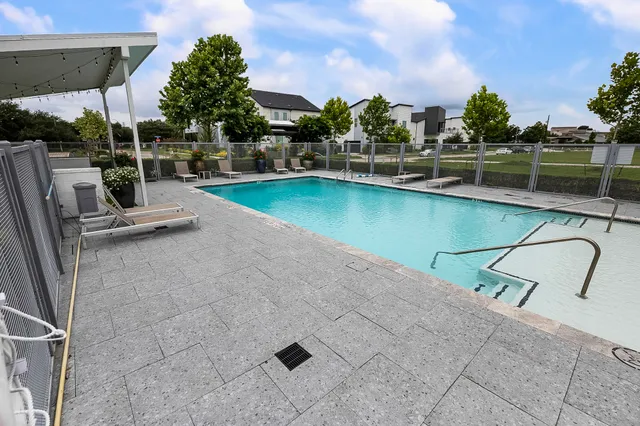 a view of a swimming pool with a patio