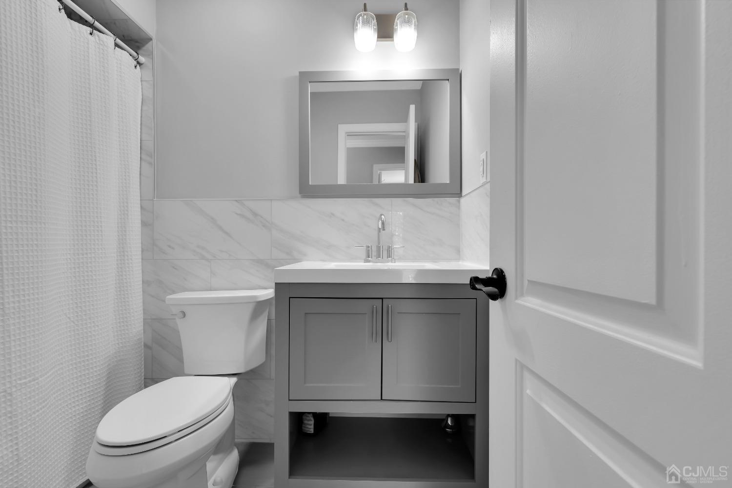 435 Teaneck Road, Unit 21 Ridgefield Park, NJ 07660 - Photo 11 of 20 a bathroom with a toilet sink and mirror