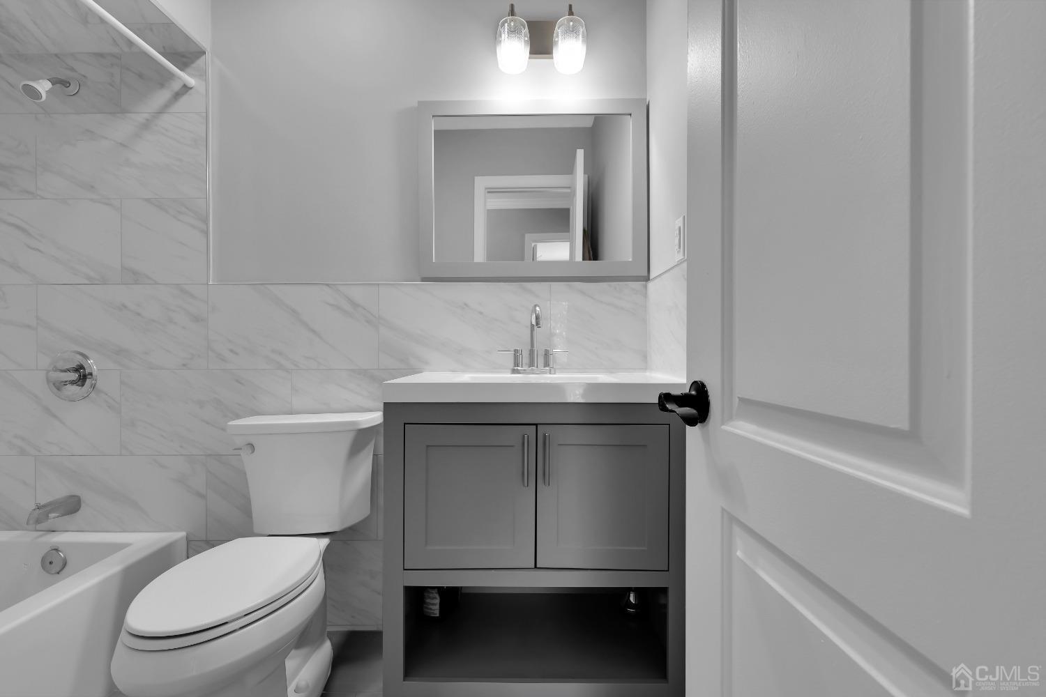 435 Teaneck Road, Unit 21 Ridgefield Park, NJ 07660 - Photo 12 of 20 a bathroom with a toilet sink and mirror