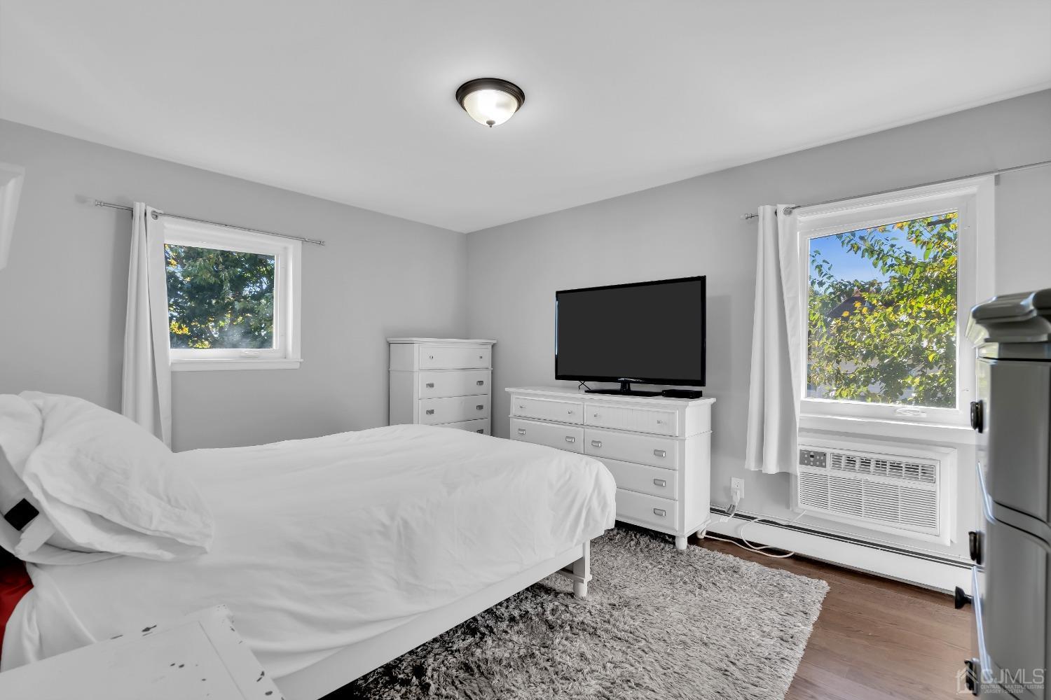 435 Teaneck Road, Unit 21 Ridgefield Park, NJ 07660 - Photo 13 of 20 a bedroom with a bed and a flat screen tv